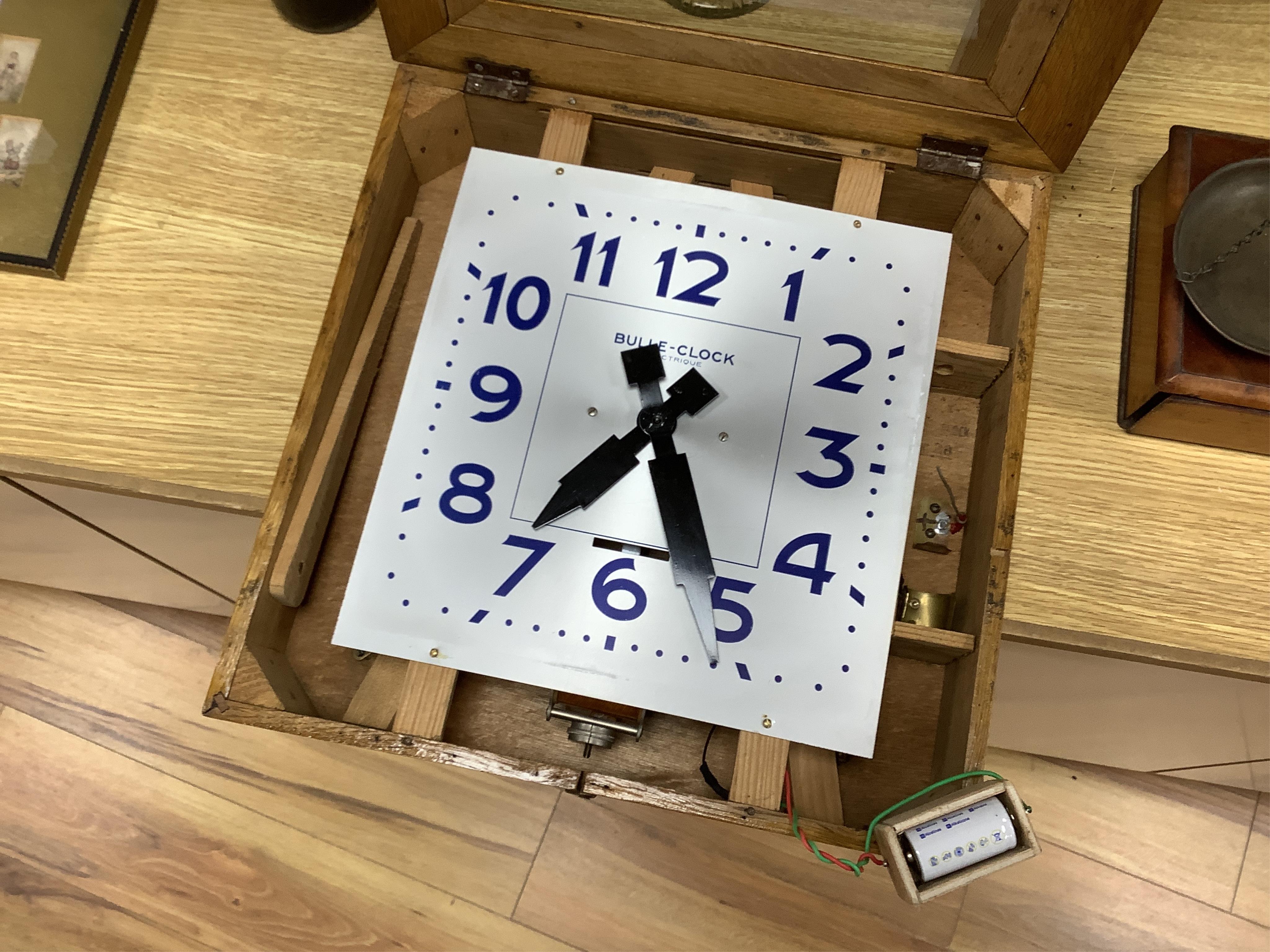 An early 20th century French Art Deco Bulle Electrique oak wall clock, 39cm squared. Condition - scratch to oak on front cover, not checked if working